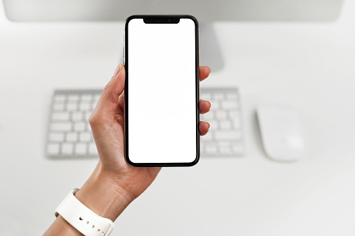 Istanbul, Turkey - December 15, 2018: The new Apple iPhone X Silver Color 256GB Model with White Blank Screen at Office.