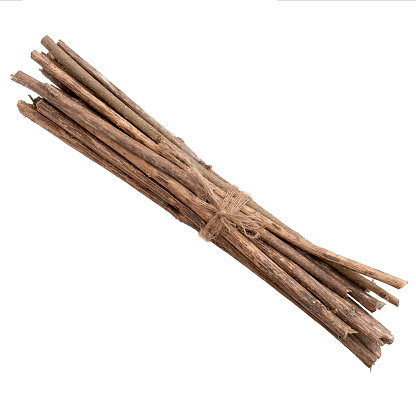 Bundle of twigs, sticks isolated over white and tied with string.