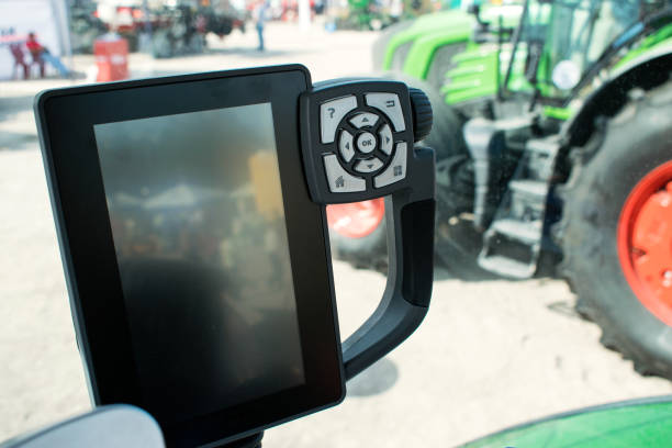 Traktor cabin device. Inside modern tractor. Control panel with buttons, monitor, screen, Steering wheel. View from work place.