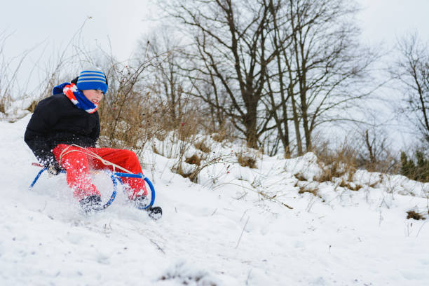 istock for a sledge down the boy in red pants is very happy 1096587318