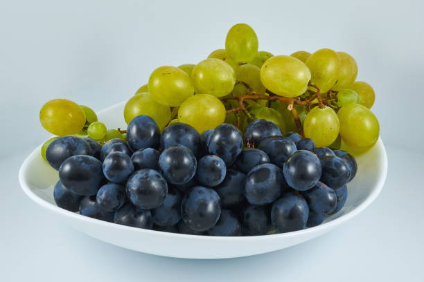 istock White grapes, black grapes on a white plate 1096588124