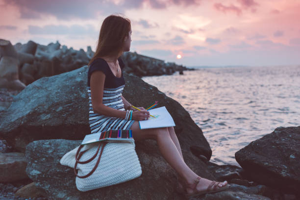 istock Relaxed woman drawing at the beach 1096591596
