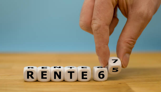 istock Retirement with 65 or 67? Hand is turning a dice and changes the expression 
