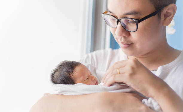 portrait of young asian father holding his newborn baby with copy space.  lifestyle together single dad father's day holiday concept - human face chinese ethnicity close up men imagens e fotografias de stock