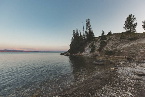 istock Beautiful Yellowstone Lake, Water's Edge, Mountain Range at Sunset 1096604794