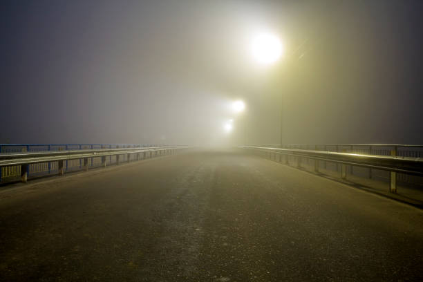 istock Thick fog over empty road at night 1096611640