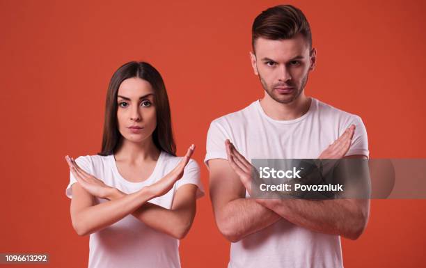 Serious Man And Woman Show On Camera The Disagree Sign Or Gesture Stock Photo - Download Image Now