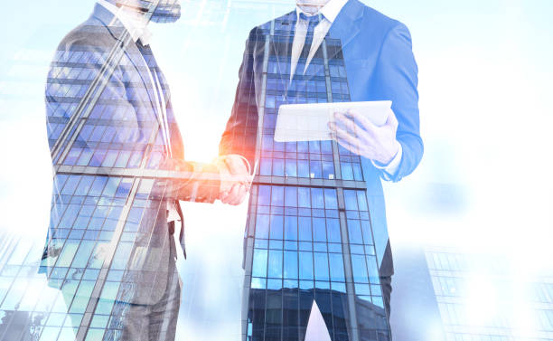 istock Businessmen shake hands, skyscrapers 1096624046