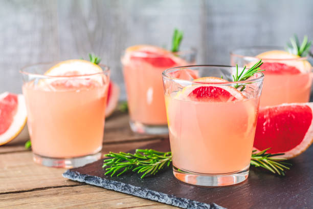 istock Alcoholic cocktail with grapefruit drink glass on a black stone board 1096624372