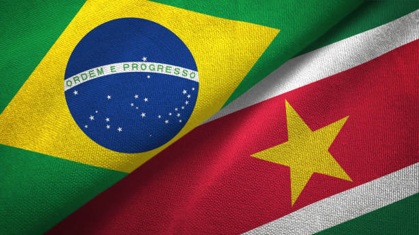 istock Suriname and Brazil two flags together textile cloth, fabric texture 1096626080