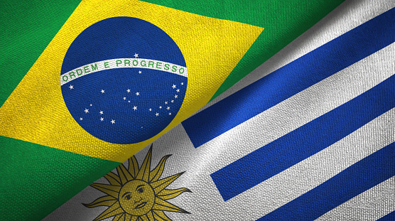 Uruguay and Brazil flags together textile cloth, fabric texture