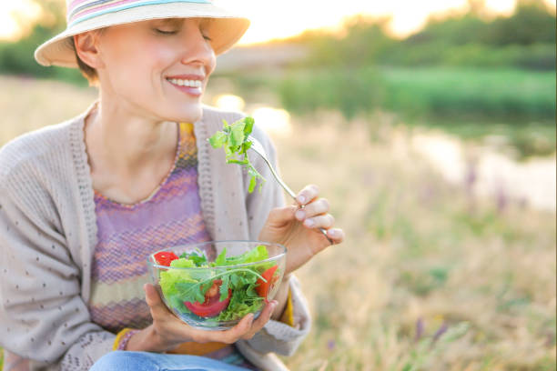 istock Young woman eating salad 1096626492