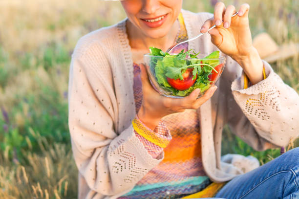istock Young woman eating salad 1096626498
