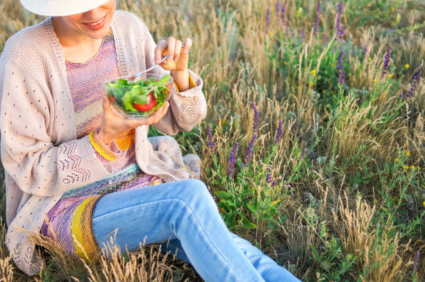 istock Young woman eating salad 1096626504