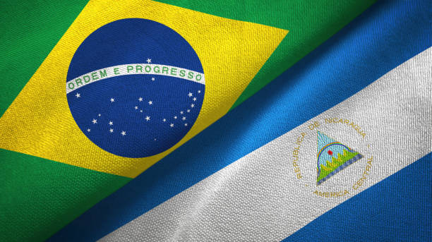 istock Nicaragua and Brazil two flags together textile cloth, fabric texture 1096626822