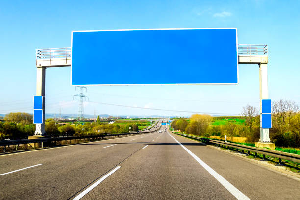 istock Blank blue freeway sign over the road on sunny day 1096633644