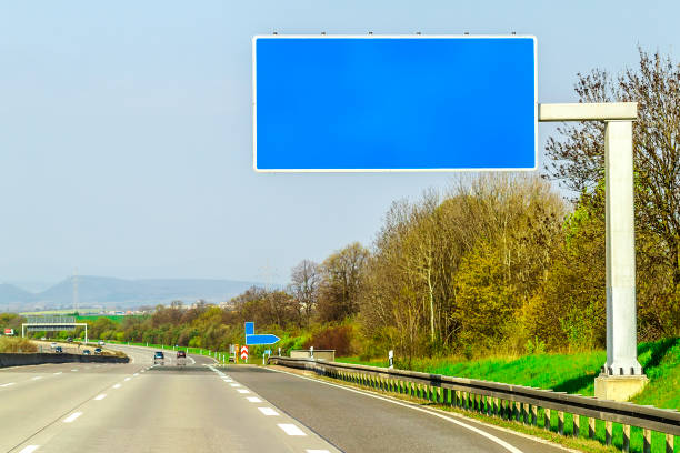 istock Blank blue freeway sign over the road on sunny day 1096633682