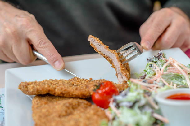 istock Man Eating Crispy Pork Cutlets 1096637966