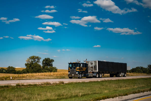 Transport truck traveling on the highway I-80 Interstate 80 (I-80), IA, USA - September 12, 2018: Transport truck traveling on the highway I-80 starlitetrucking stock pictures, royalty-free photos & images