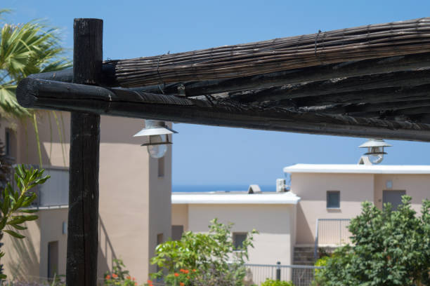 Canopy from wooden levels against the sky and cottage, Cyprus.