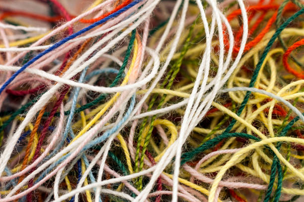 Multi-colored tangled colorful needlecraft silk thread rope. Macro shot. Abstract colors background