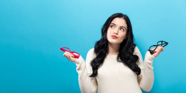 istock Young woman comparing two eye glasses 1096659530