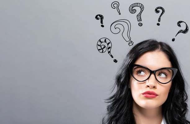 istock Hand draw question marks with young businesswoman 1096659722