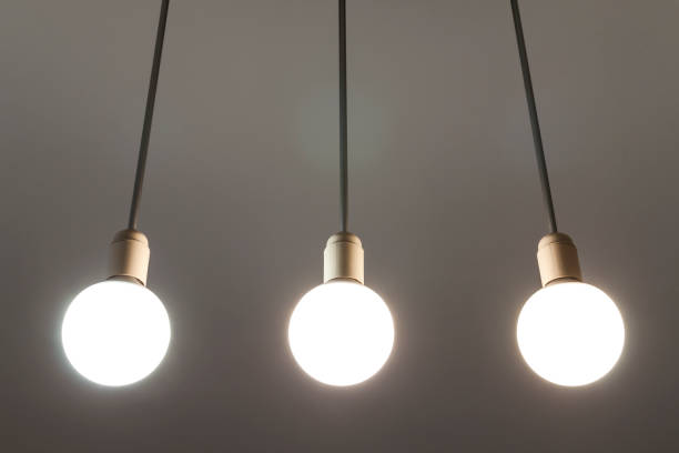 istock LED white bulbs hanging from the ceiling. Illumination technology. 1096659952