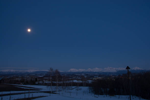 istock Twilight Sky with full moon in Biei and Tokachi mountain range 1096665990