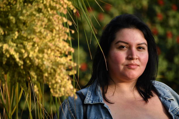 istock Young Woman in Jean Jacket with Plants 1096686850