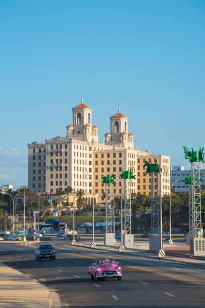 National hotel in Havana. Cuba Pink convertible car on the Malecon Avenue in front of the National Hotel, this is the flagship and most famous hotel in the city. Havana. Cuba. January 2, 2019 old havana stock pictures, royalty-free photos & images