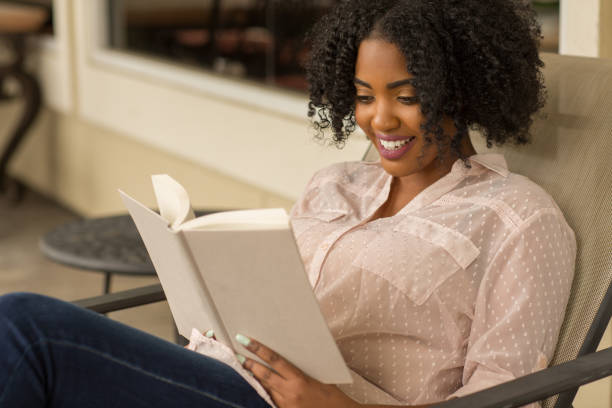 istock African American woman reading a book. 1096704328