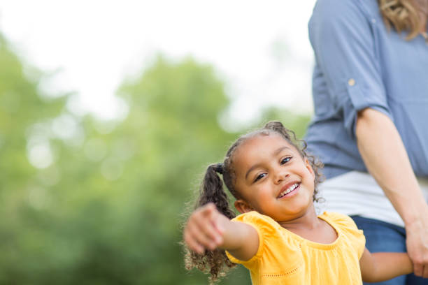 istock Mother and daughter laughing and playing at the park. 1096708432