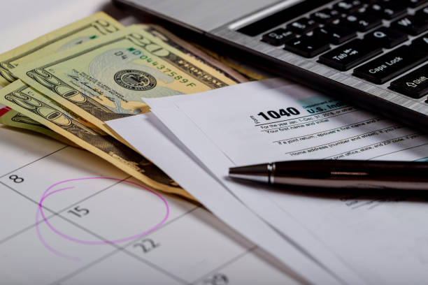 Tax Day , dollars and form 1040 income tax form showing tax day for April Calendar with words Calendar with words Tax Day , dollars and form 1040 income tax form showing tax day for April IRS Headquarters Building stock pictures, royalty-free photos & images