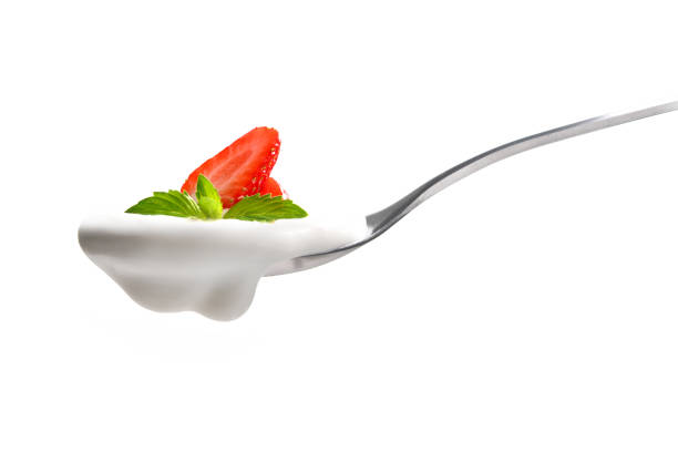 istock Plain yogurt on a spoon with fresh strawberry on top isolated on white background 1096734092