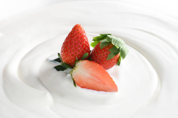 istock Top view of plain yogurt with fresh strawberries on top isolated on white background 1096734108