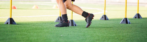 istock soccer player Jogging and jump between marker and yellow hurdles. 1096744706