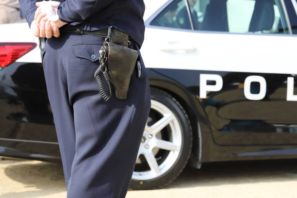Japanese police officer with patrol car stock photo