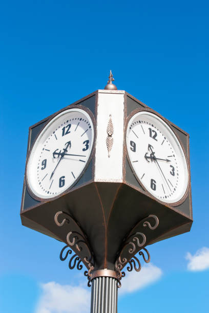 istock Cast iron pillar with street clock against a cloudy blue sky 1096751806