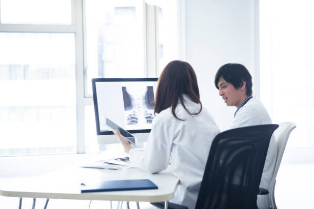 istock A doctor is talking in front of a personal computer. 1096754126