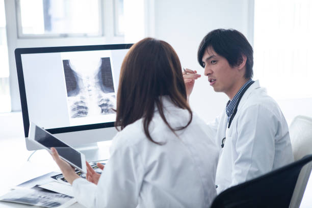 istock A doctor is talking in front of a personal computer. 1096754130