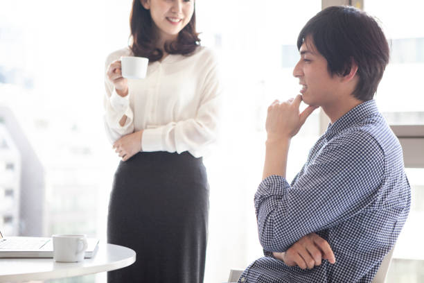istock Men and women talking during a break in the office. 1096754338
