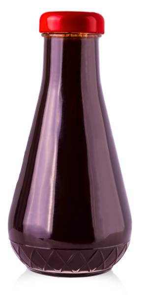 istock The glass bottle with dark sauce on a white 1096756158