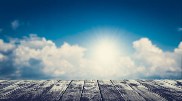istock Empty wooden floor with blurred cloudy blue sky background. 1096756498