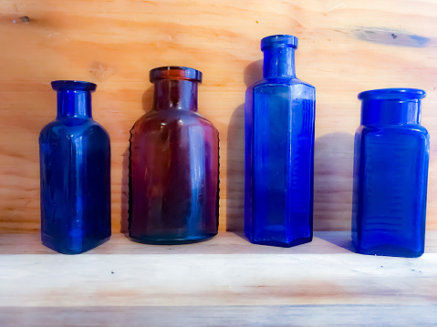 Picture of antique bottles displayed in an old fashioned container gives a pleasant reminder of days gone by.