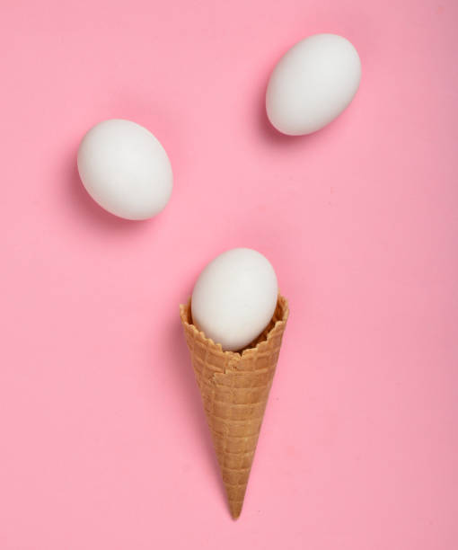 istock White chicken eggs in a waffle horn on a pink background, top view, flat lay, minimalist trend 1096763234