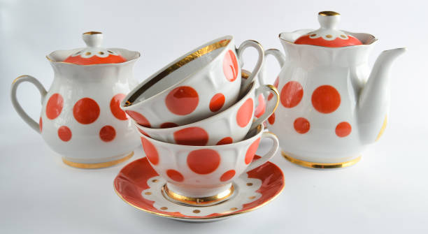 istock Stack of antique ceramic cups on a saucer, teapots, sugar bowls on a white background 1096764716