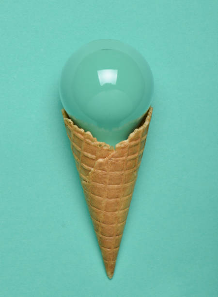 istock Creative, conceptual layout, painted incandescent bulb in a waffle horn on a mint pastel background, top view, minimalist trend 1096765014