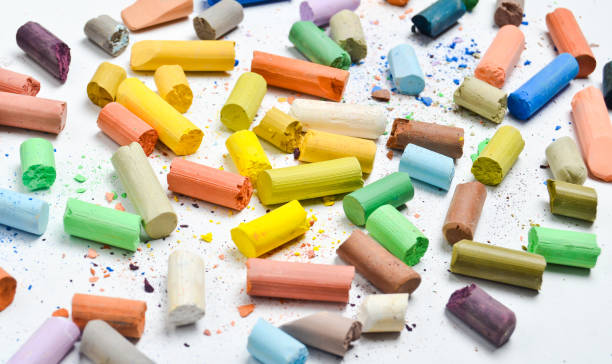 istock Background of many multicolored pastel crayons on a white background, top view 1096765038