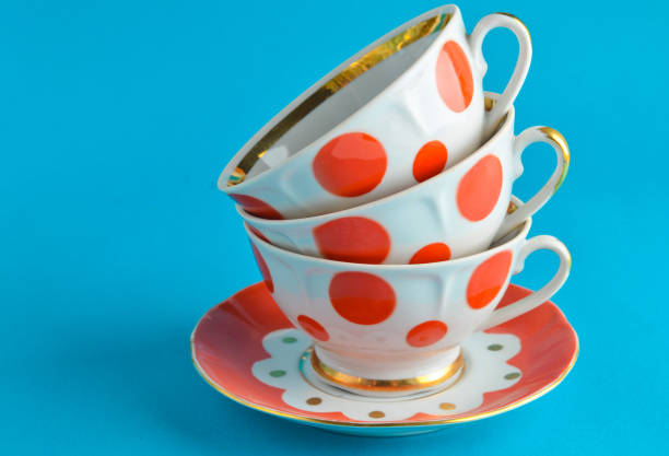 istock stack of antique ceramic cups on a saucer on a blue background, copy space 1096765296